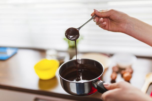 crop-hands-with-chocolate-sauce_23-2147758356