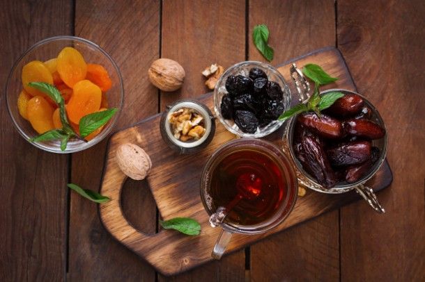 mix-dried-fruits-date-palm-fruits-prunes-dried-apricots-raisins-and-nuts-and-traditional-arabic-tea-ramadan-ramazan-food-top-view_2829-318