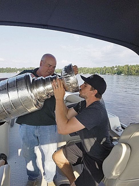 matt_niskanen_enjoys_a_sip_from_the_stanleycup_while_boating_with_his_dad-2018__